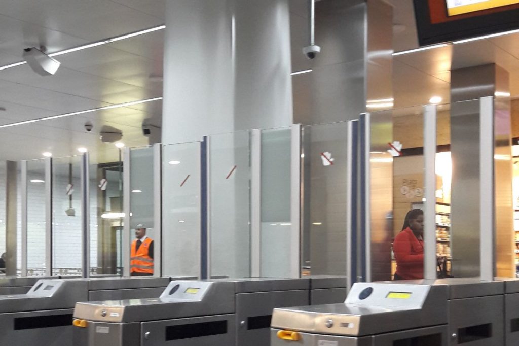 Surveillance camera watching over fare gates at a FGC station in Barcelona